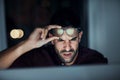 Are you kidding me. a young businessman looking angry while using a computer during a late night at work. Royalty Free Stock Photo