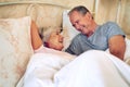 You know just how to make me laugh. a senior couple being affectionate in their bedroom.