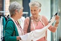 You know what I always say...Buy it. a two senior women out on a shopping spree. Royalty Free Stock Photo