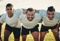 You know what were here for. Cropped portrait of a group of three young rugby players lining up for a scrum on the field Royalty Free Stock Photo