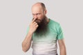You are liar. Portrait of angry middle aged bald man with long beard in green t-shirt standing, looking and pointing at his nose, Royalty Free Stock Photo