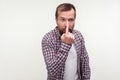 You are liar! Portrait of bearded man touching his nose showing lie gesture. on white background