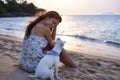 You like it here. an attractive young woman enjoying the beach with her dog. Royalty Free Stock Photo