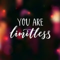 You are limitless. Encouraging quote. Motivational saying, brush lettering on dark background with pink bokeh.