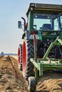 You look past a tractor at an asparagus field in Germany. The focus lies on the tire of the tractor, the horizon is somewhat out o Royalty Free Stock Photo