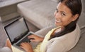 You looking at my emails. Portrait of an attractive young woman using her laptop while sitting on the sofa. Royalty Free Stock Photo