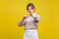 You are loser! Portrait of serious bossy woman with fair hair in casual beige blouse, isolated on yellow background