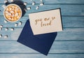 YOU ARE SO LOVED text on valentine postcard inscription positive quote phrase Greeting card blue envelope with white cup