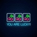 You are lucky - glowing neon motivation phrase with cherry on slot machine. Slot machine win combination with cherries