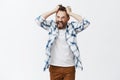 You make me man. Portrait of stressed intense and bothered crazy bearded man, pulling hair out of head and screaming Royalty Free Stock Photo