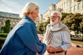 You are making me happy! Beautiful elderly couple holding hands and looking at each other with smile while standing Royalty Free Stock Photo