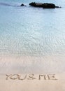 You and me message written in the sand on a beautiful beach Royalty Free Stock Photo
