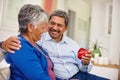 Because you mean so much to me. a loving senior man giving his wife a gift for Valentines Day. Royalty Free Stock Photo