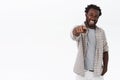 You are my buddy. Friendly and carefree, enthusiastic african-american bearded man in shirt, t-shirt, pointing camera Royalty Free Stock Photo