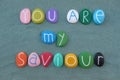 You are my saviour, multicolored handmade stone letters over green sand