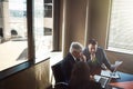 You need to meet to move forward. High angle shot of three businesspeople working in the boardroom. Royalty Free Stock Photo