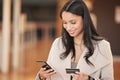 You never have to miss another bill. a young woman using her smartphone to make an online payment using her credit card. Royalty Free Stock Photo