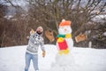 You are next. happy hipster ready to celebrate xmas. bearded man build snowman. winter holiday outdoor. warm sweater in