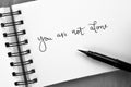 YOU ARE NOT ALONE hand-lettered in notepad Royalty Free Stock Photo