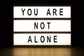 You are not alone light box sign board Royalty Free Stock Photo