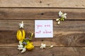 You are not alone message card handwriting  with white flowers jasmine, yellow flowers ylang ylang Royalty Free Stock Photo