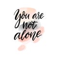 You are not alone. Support quote. Inspirational saying, handwritten calligraphy text on abstract pink and gray