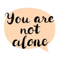 You are not alone text. Brush calligraphy. Royalty Free Stock Photo