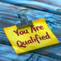 You Are Qualified Note on Clip. Generative ai. Royalty Free Stock Photo