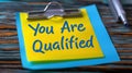 You Are Qualified Note on Clip. Generative ai. Royalty Free Stock Photo