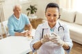 Nice cheerful doctor looking at the syringe Royalty Free Stock Photo