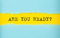 ARE YOU READY text on the torn paper , yellow background Royalty Free Stock Photo