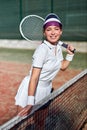 Are you ready to play. Positive sexy beautiful woman in sports clothing holding tennis racket Royalty Free Stock Photo