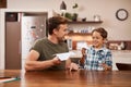 Are you ready to take off. a man and his young son playing with paper planes at home. Royalty Free Stock Photo