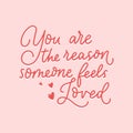 You are the reason someone feels loved inspirational red lettering quote isolated on pink background