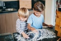 You say baking, we say art. two adorable little boys baking together at home.