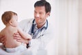 You seem to be a healthy little girl. A young male doctor examining an infant girl. Royalty Free Stock Photo