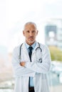 You seriously need a doctor more like me. a mature male doctor standing with his arms crossed. Royalty Free Stock Photo