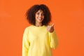 You should come and see it. Carefree good-looking hipster girl yellow sweater, inviting come inside pointing thumb Royalty Free Stock Photo