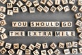 You should go the extra mile - phrase from wooden blocks with letters