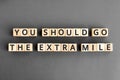 You should go the extra mile - phrase from wooden blocks with letters