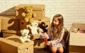 You are sure to love it. Cardboard boxes - moving to new house. happy child cardboard box. happy little girl with toy Royalty Free Stock Photo