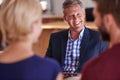 You two can be very proud of your financial decisions. Young couple discussing investment plans with a financial advisor Royalty Free Stock Photo