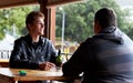 Are you up for round two. Two young men sitting at a restaurant drinking beers and having a friendly discussion. Royalty Free Stock Photo