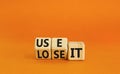 You use or lose it symbol. Concept word Use It or lose it on wooden cubes. Beautiful orange table orange background. Business and Royalty Free Stock Photo