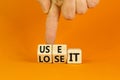 You use or lose it symbol. Concept word Use It or lose it on wooden cubes. Beautiful orange table orange background. Businessman Royalty Free Stock Photo