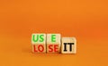 You use or lose it symbol. Concept word Use It or lose it on wooden cubes. Beautiful orange table orange background. Business and Royalty Free Stock Photo