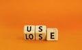 You use or lose it symbol. Concept word Use or lose on wooden cubes. Beautiful orange table orange background. Business and you Royalty Free Stock Photo