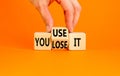 You use or lose it symbol. Concept word You use or lose it on wooden cubes. Beautiful orange table orange background. Businessman Royalty Free Stock Photo