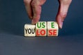 You use or lose it symbol. Concept words You use and You lose on wooden cubes. Businessman hand. Beautiful grey table grey Royalty Free Stock Photo