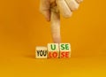 You use or lose it symbol. Concept words You use and You lose on wooden cubes. Businessman hand. Beautiful orange table orange Royalty Free Stock Photo